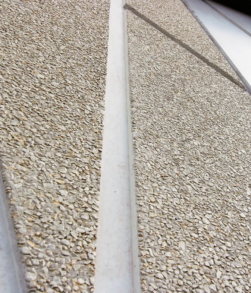 Exposed aggregate concrete feature wall in a contemporary Uganda interior