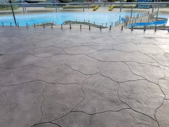 Uneven concrete area with pooling water before resurfacing Uganda