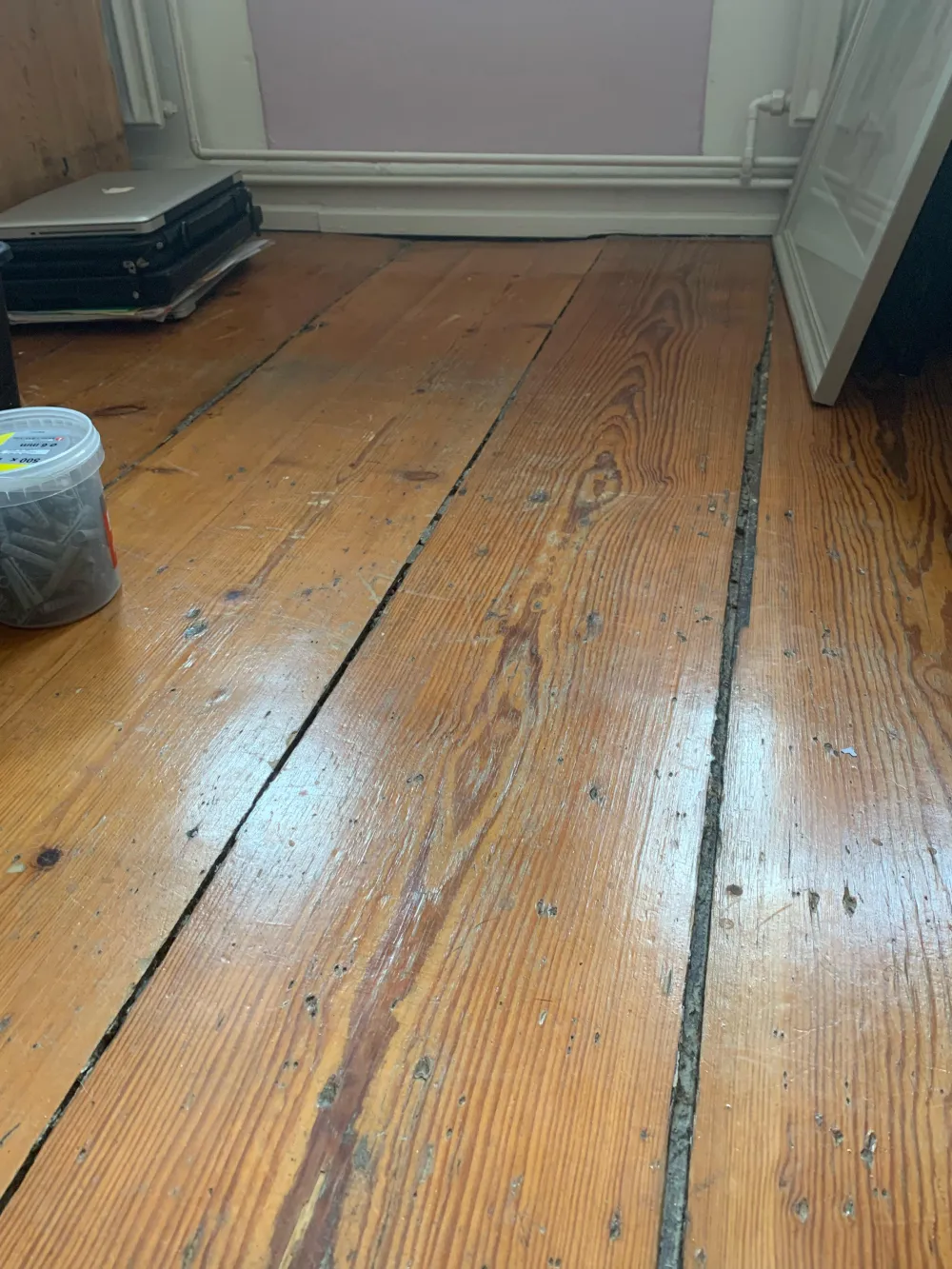 Loose and damaged hardwood boards before repair Uganda