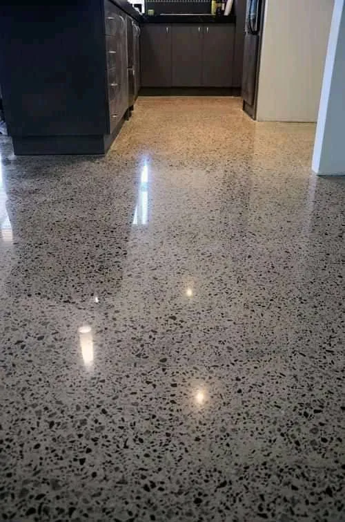 Smooth grey polished concrete floor finish in a Kampala home
